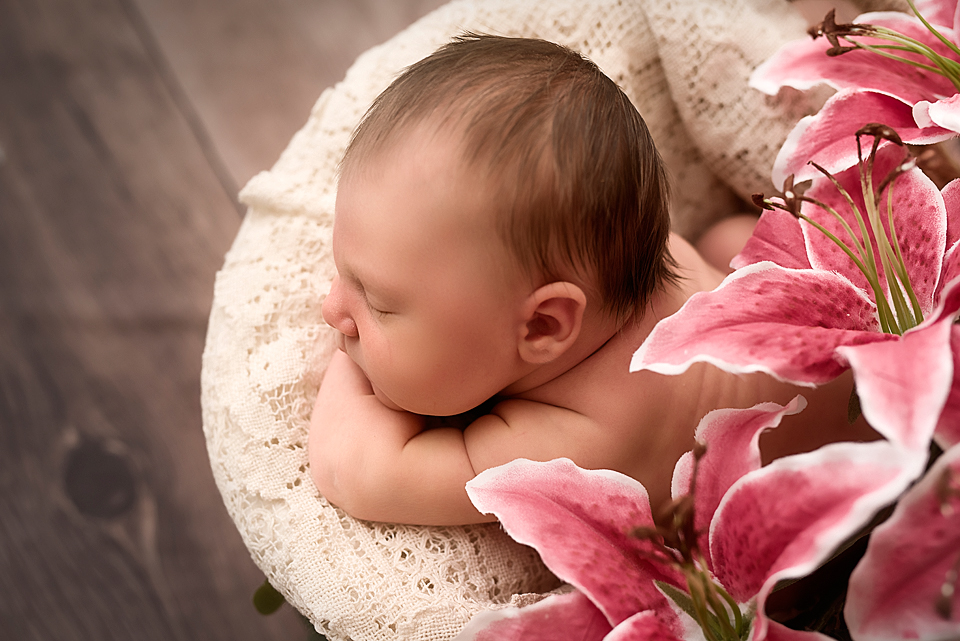 Newborn Baby Girl in Basket with Flowers